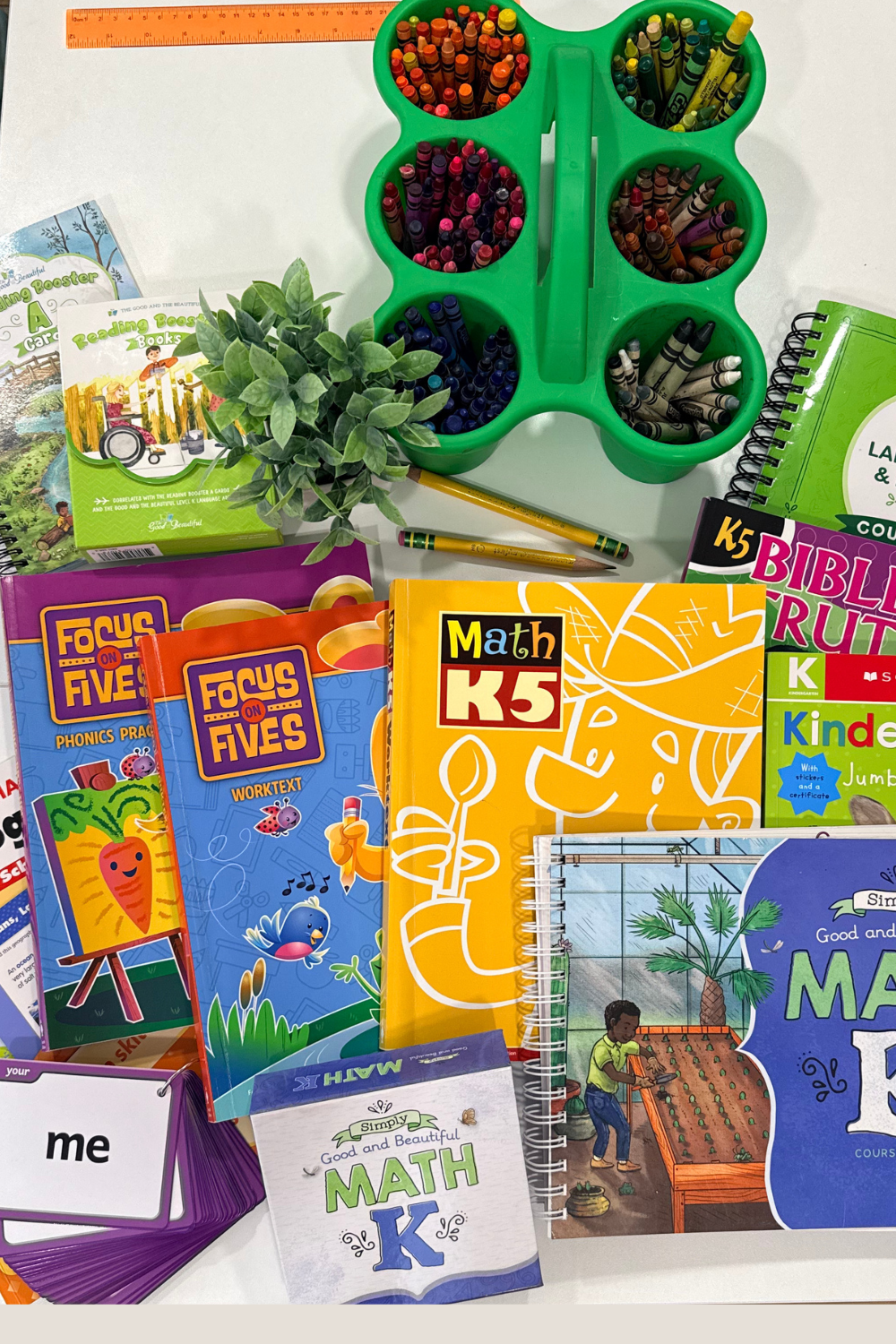 Complete Kindergarten homeschool curriculum setup featuring BJU Press Online Homeschool, The Good and the Beautiful, phonics tools, handwriting workbooks, and geography resources for a faith based homeschool family