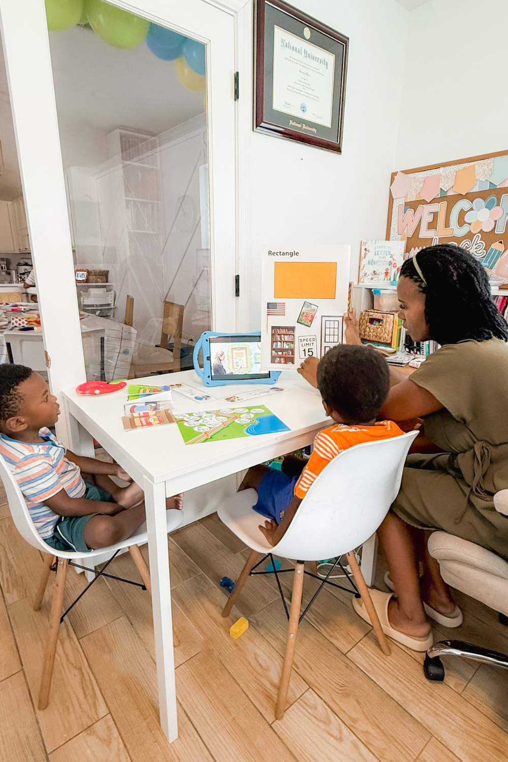 Homeschool mom teaching her Kindergartener and Preschooler using BJU Press Homeschool Online curriculum during a parent supported homeschool lesson at home